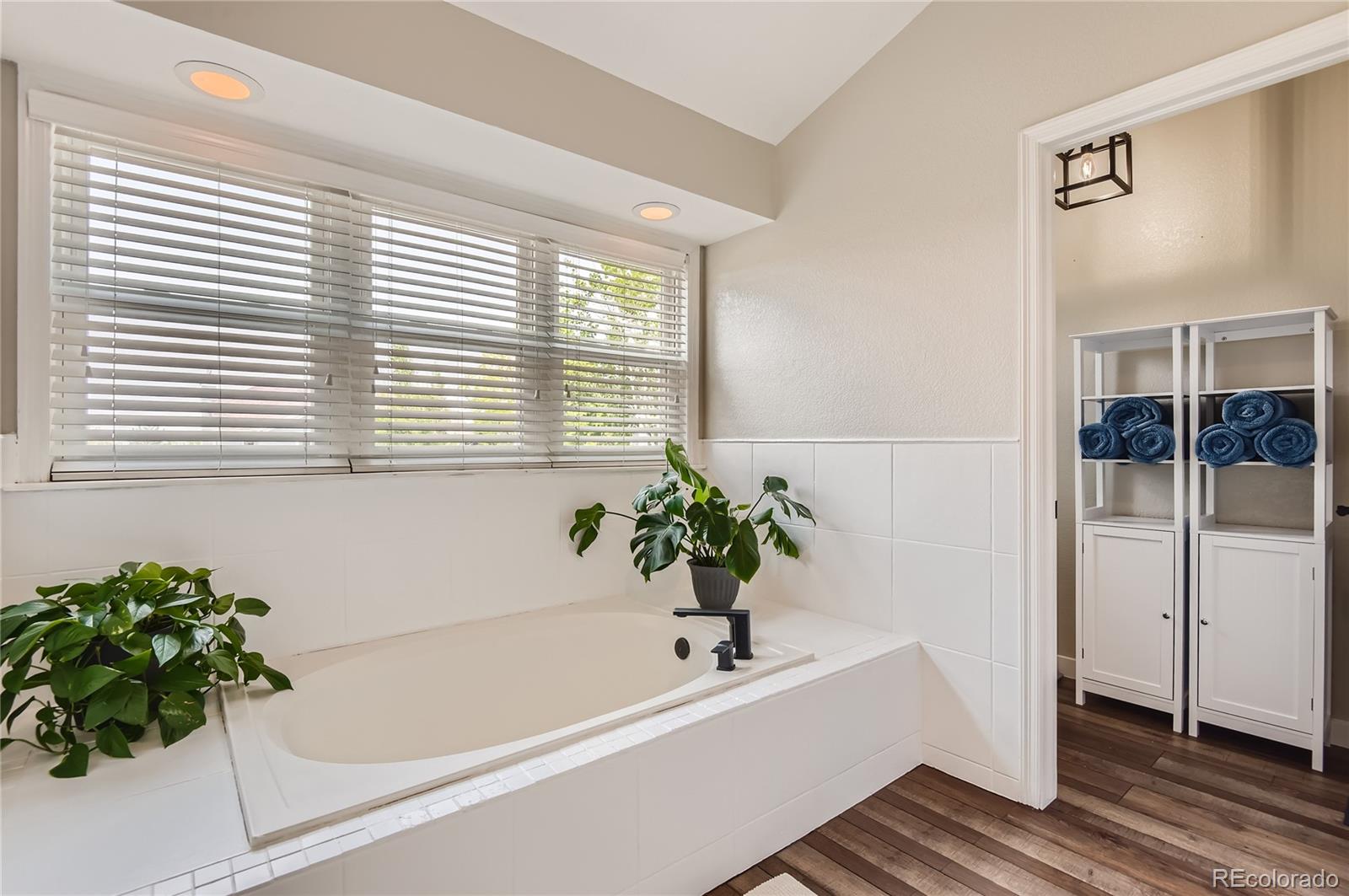 9212 Princeton Street Highlands Ranch, CO 80130 - Photo 24 of 40 a white bath tub sitting in a bathroom next to a window