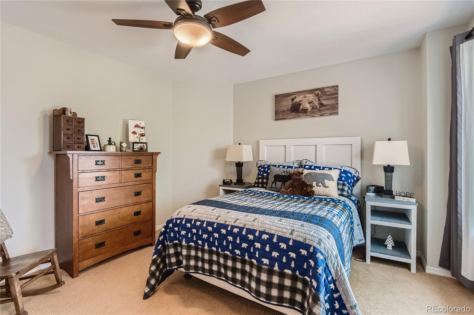 9212 Princeton Street Highlands Ranch, CO 80130 - Photo 27 of 40 a bedroom with a bed and a cabinets