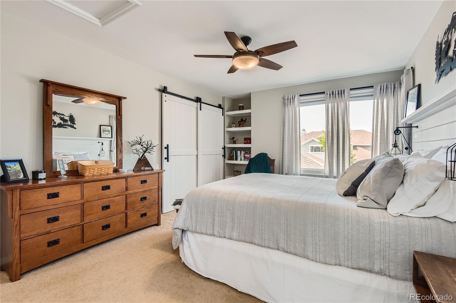 9212 Princeton Street Highlands Ranch, CO 80130 - Photo 29 of 40 a bedroom with a bed and a dresser