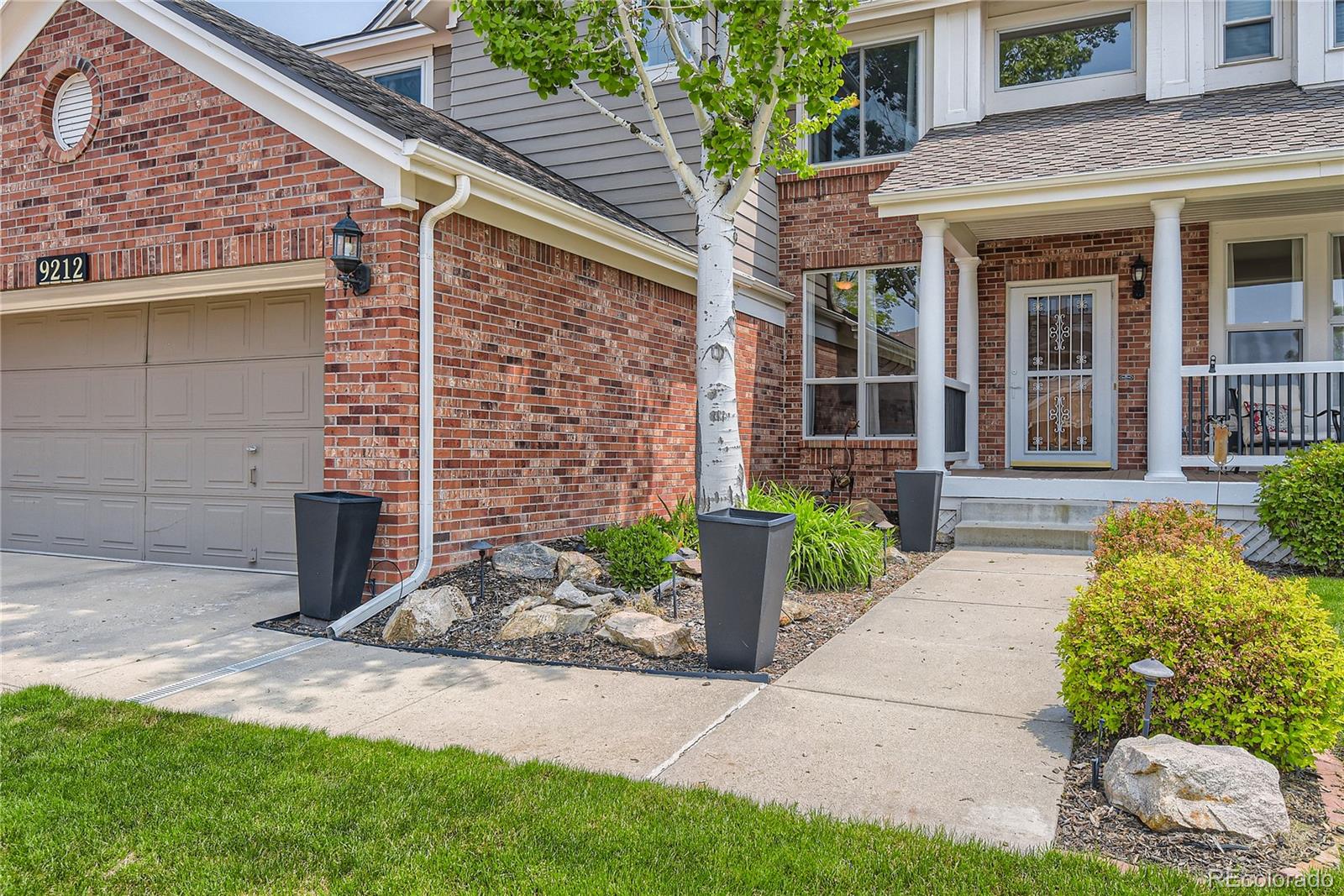 9212 Princeton Street Highlands Ranch, CO 80130 - Photo 3 of 40 a front view of a house with garden