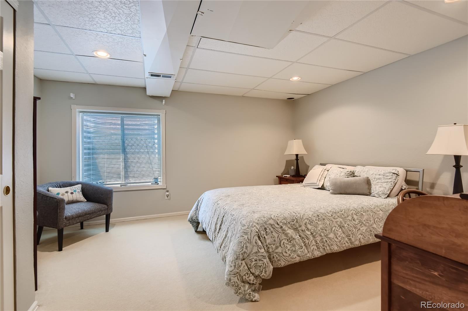 9212 Princeton Street Highlands Ranch, CO 80130 - Photo 33 of 40 a bedroom with two beds and a couch