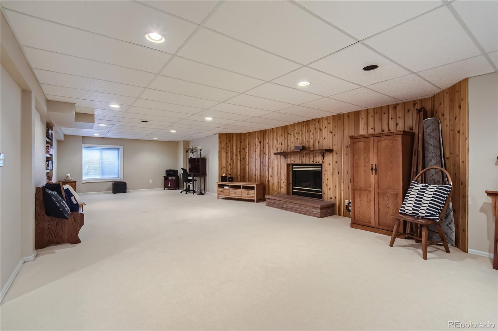 9212 Princeton Street Highlands Ranch, CO 80130 - Photo 35 of 40 a large room with furniture and a fireplace