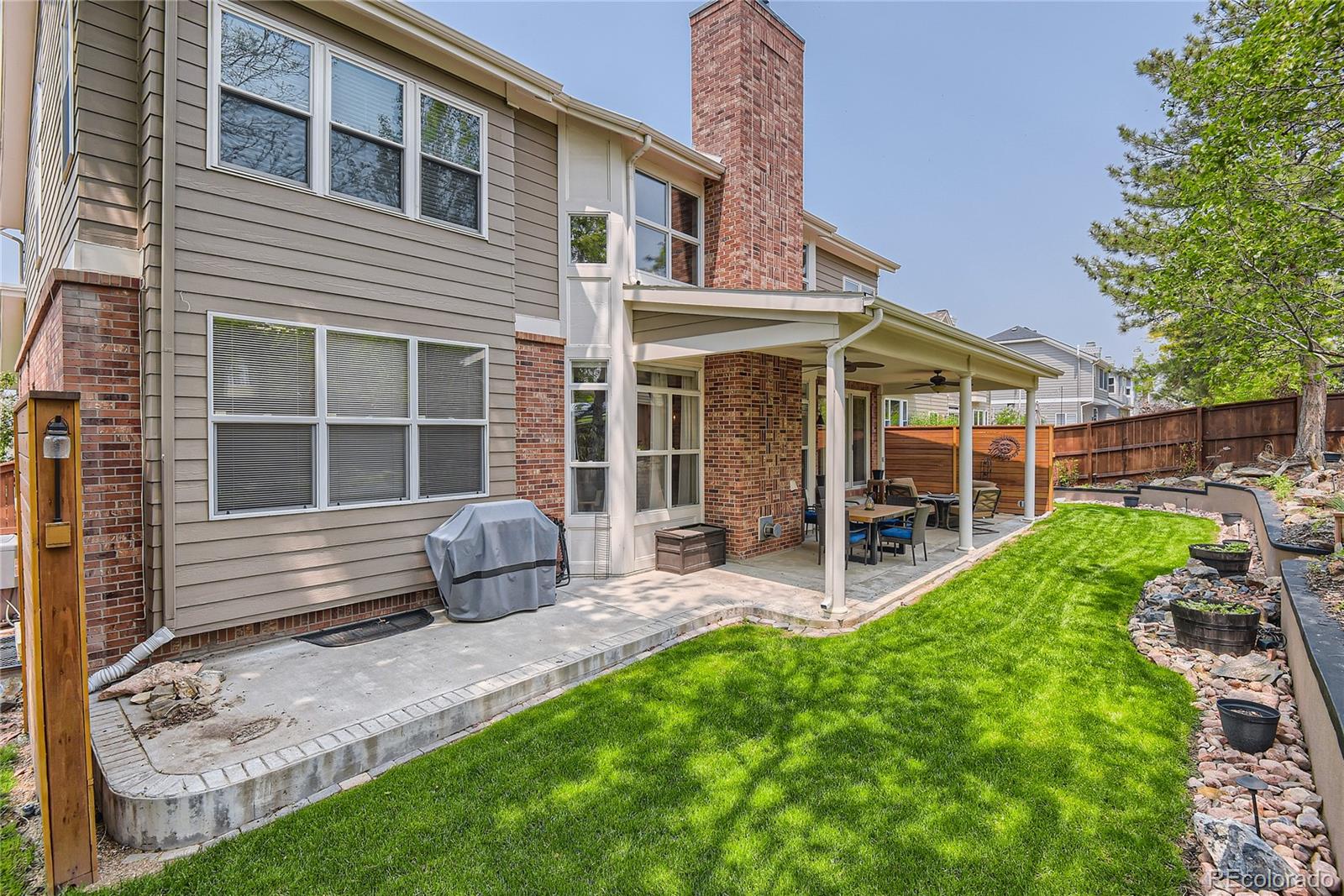 9212 Princeton Street Highlands Ranch, CO 80130 - Photo 38 of 40 a view of a house with backyard and porch