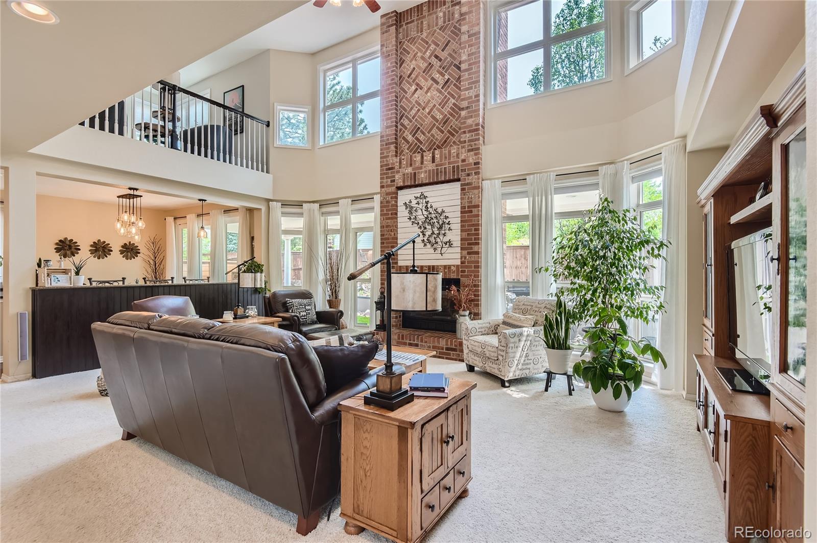 9212 Princeton Street Highlands Ranch, CO 80130 - Photo 7 of 40 a living room with furniture a window and a flat screen tv