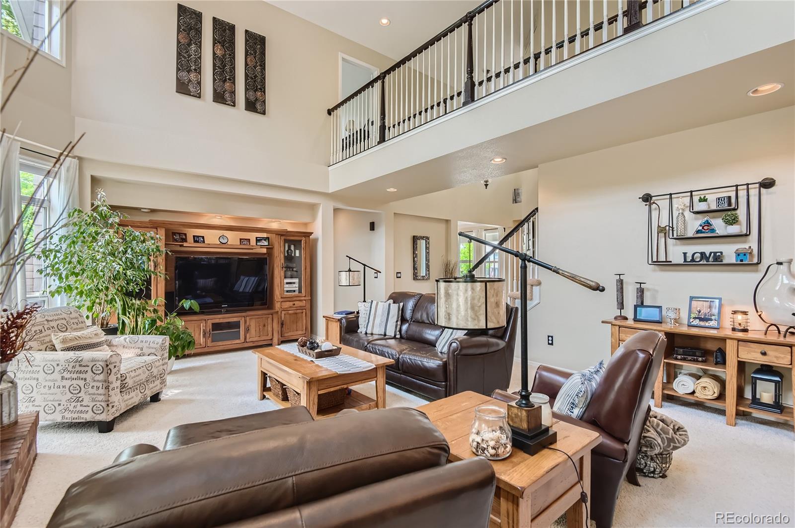 9212 Princeton Street Highlands Ranch, CO 80130 - Photo 8 of 40 a living room with furniture and a flat screen tv