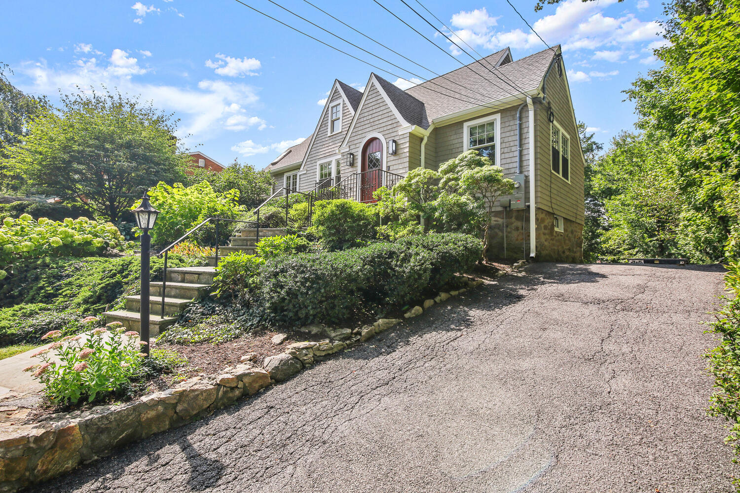 25 Butler Street Greenwich, CT 06807 - Photo 34 of 37 a front view of a house with a yard and potted plants
