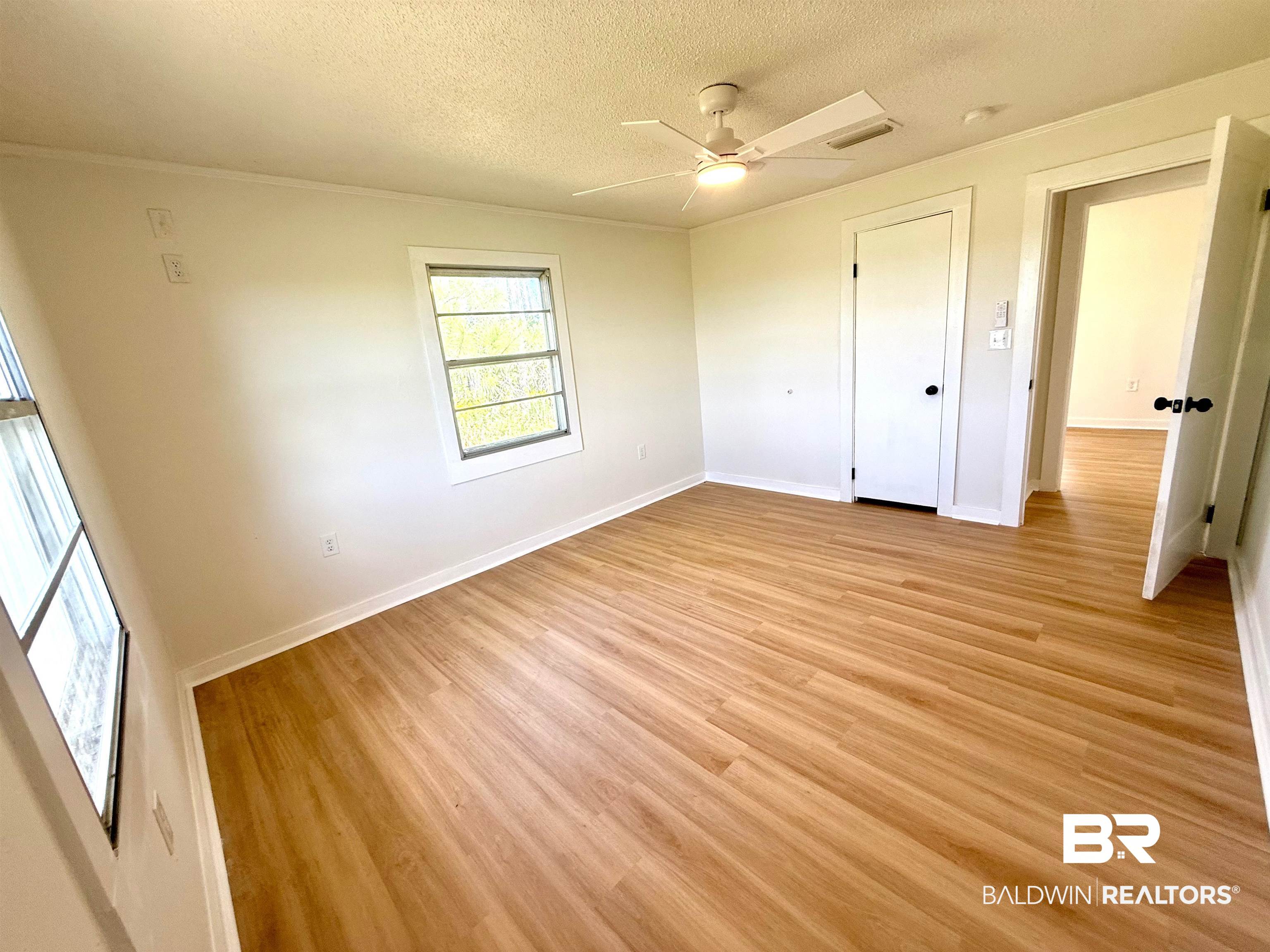 11698 Poser Road Foley, AL 36535 - Photo 13 of 20 Unfurnished bedroom featuring a textured ceiling, light wood finished floors, ceiling fan, and crown molding