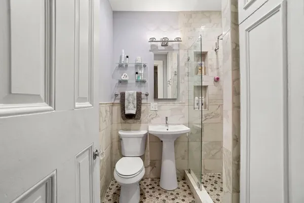 a bathroom with a sink toilet and shower