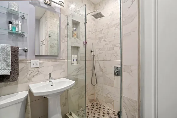 a bathroom with a sink toilet and shower