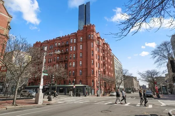 a view of a tall building next to a road