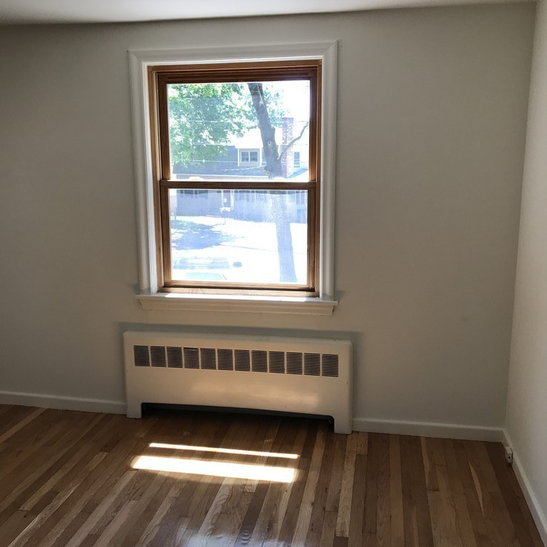 110 Clearwater Road Newton, MA 02462 - Photo 20 of 26 a view of a room with wooden floor and a window