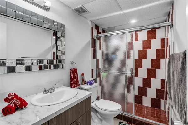 a bathroom with a sink toilet and shower