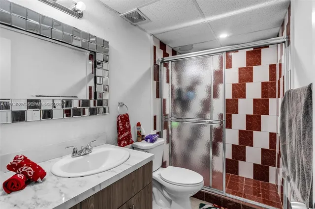 a bathroom with a sink toilet and shower