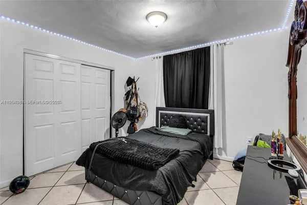 a bedroom with a bed and a potted plant