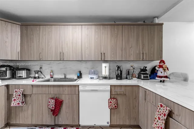 a kitchen with a sink a stove and cabinets
