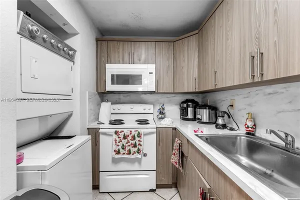 a kitchen with a sink a stove and cabinets