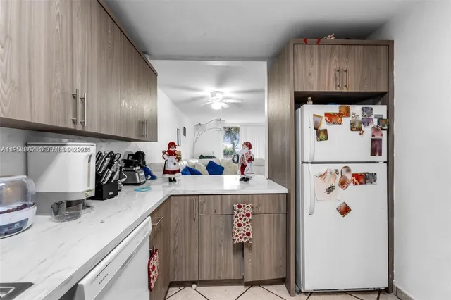 a view of kitchen with refrigerator and cabinets