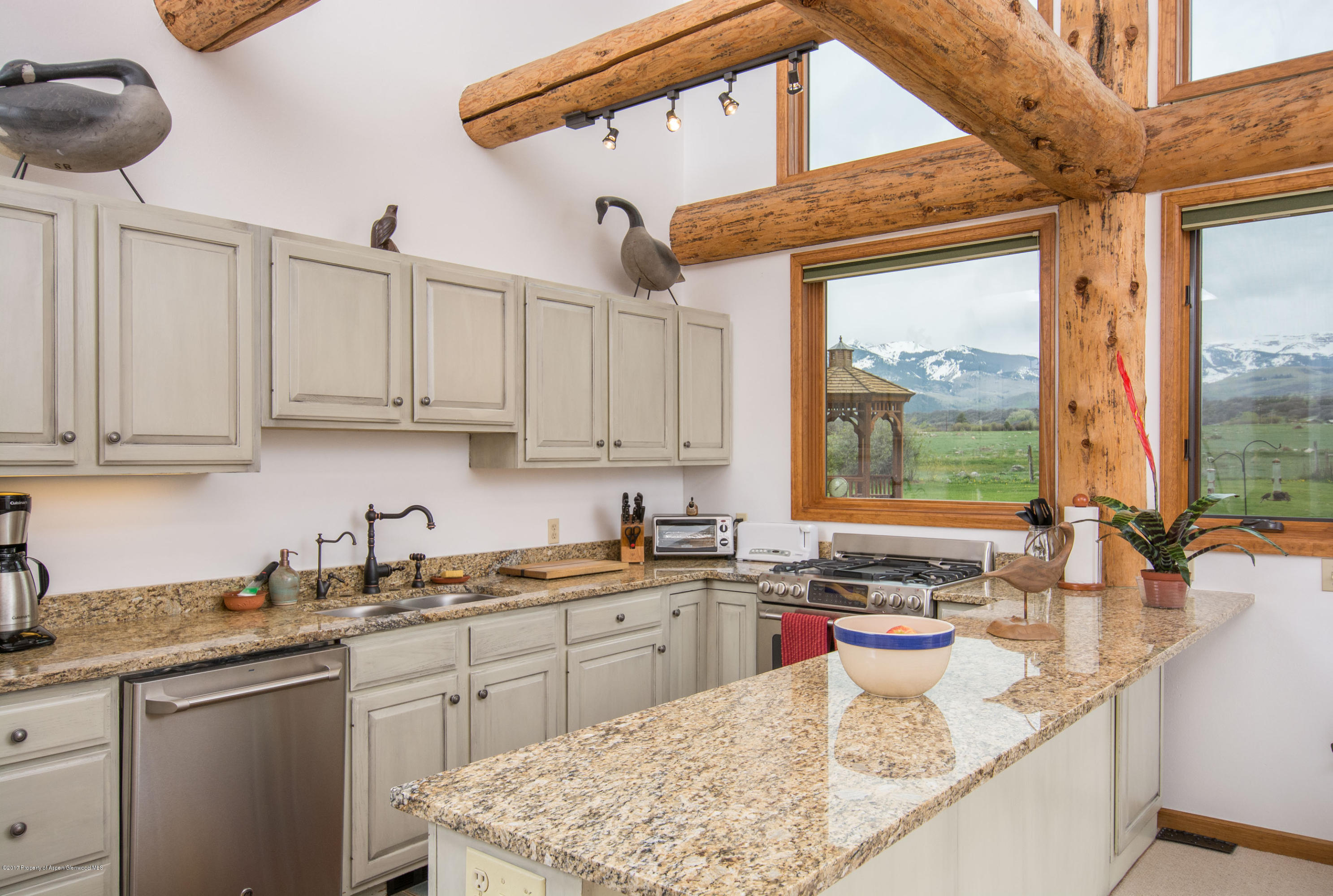144 Haystack Lane Snowmass, CO 81654 - Photo 3 of 40 a kitchen with stainless steel appliances granite countertop a sink a stove and cabinets