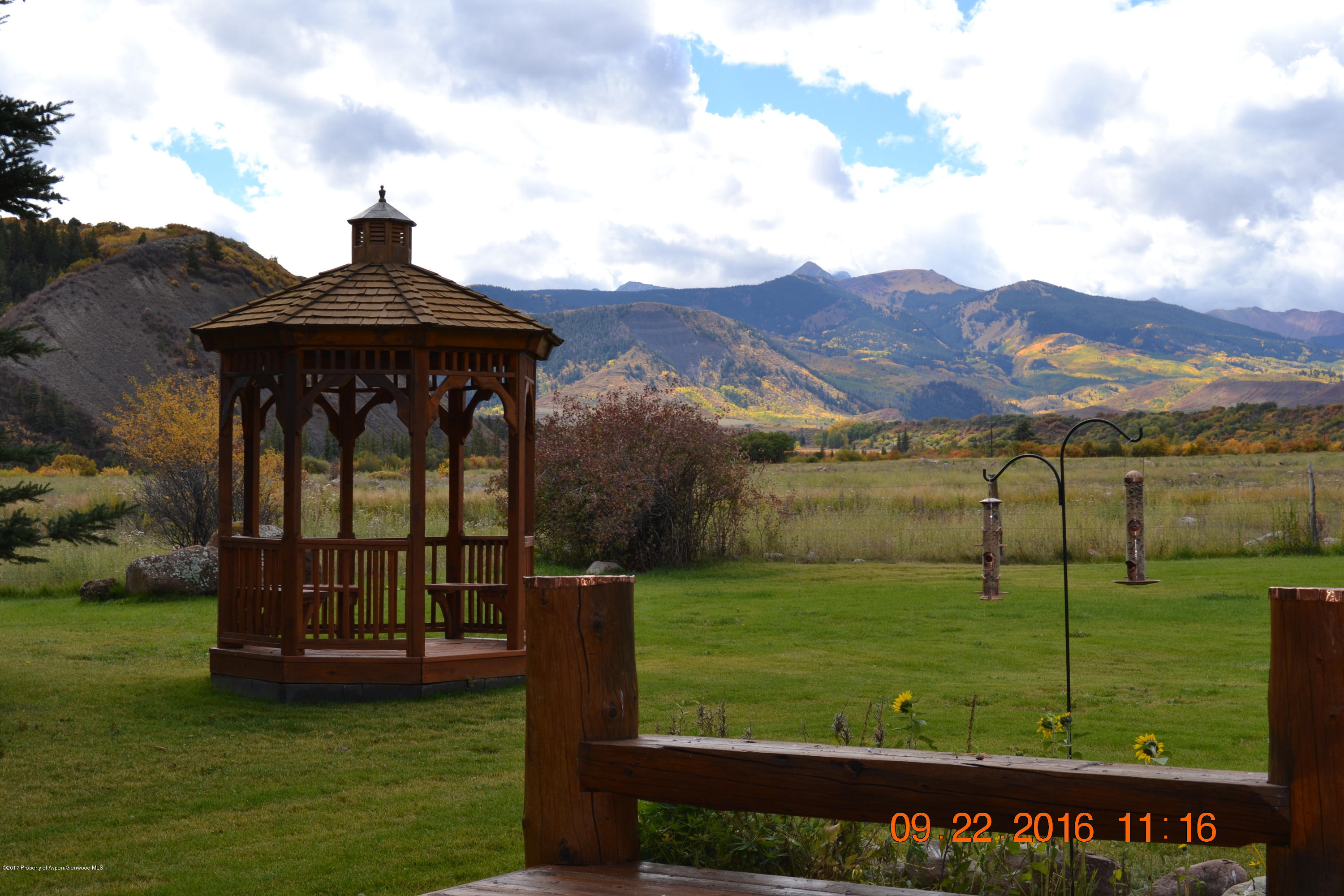 144 Haystack Lane Snowmass, CO 81654 - Photo 33 of 40 a view of a big house with a big yard potted plants and large tree