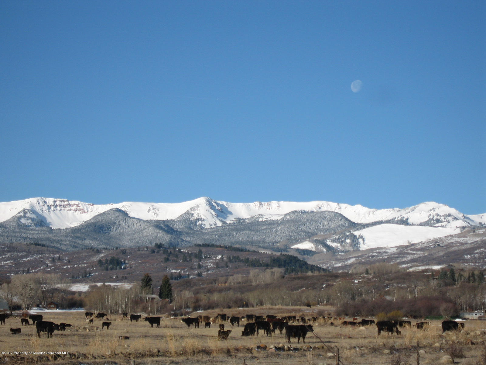 144 Haystack Lane Snowmass, CO 81654 - Photo 34 of 40 a view of a large building with mountains in the background