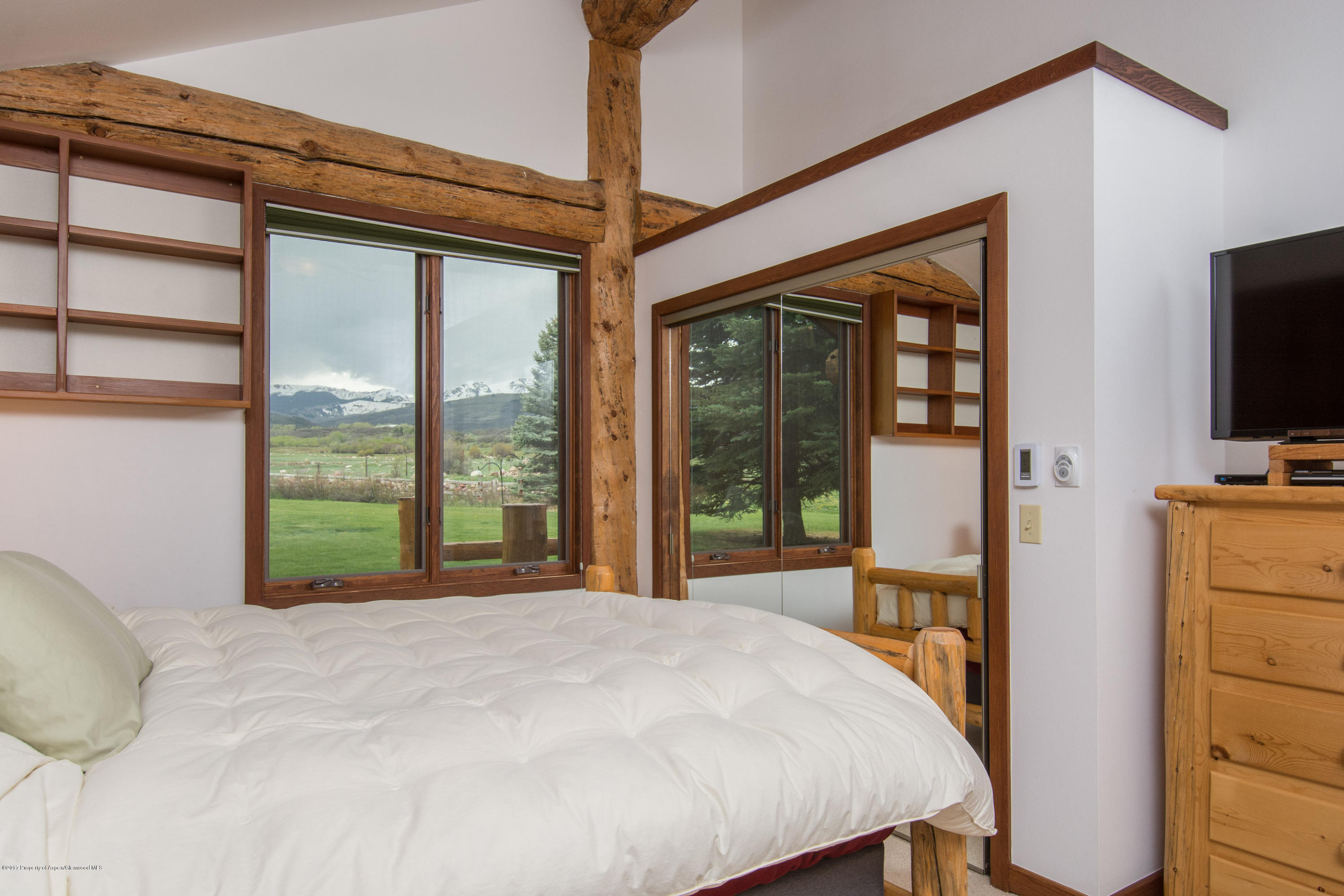 144 Haystack Lane Snowmass, CO 81654 - Photo 10 of 40 a bed sitting in a bedroom next to a window