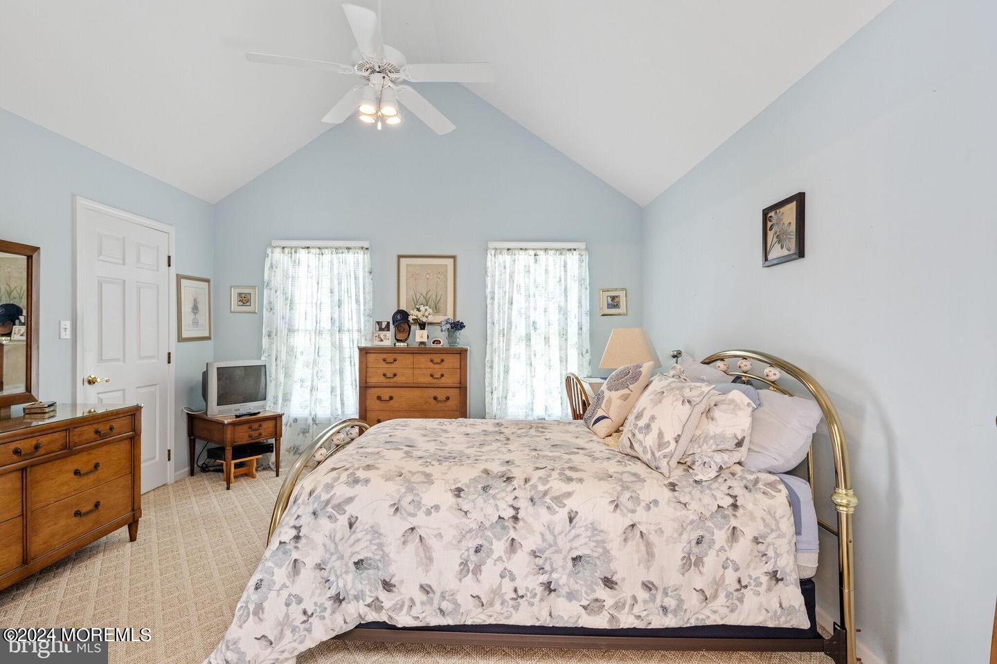 149 Sextant Road Manahawkin, NJ 08050 - Photo 6 of 8 a bedroom with a large bed and a chandelier