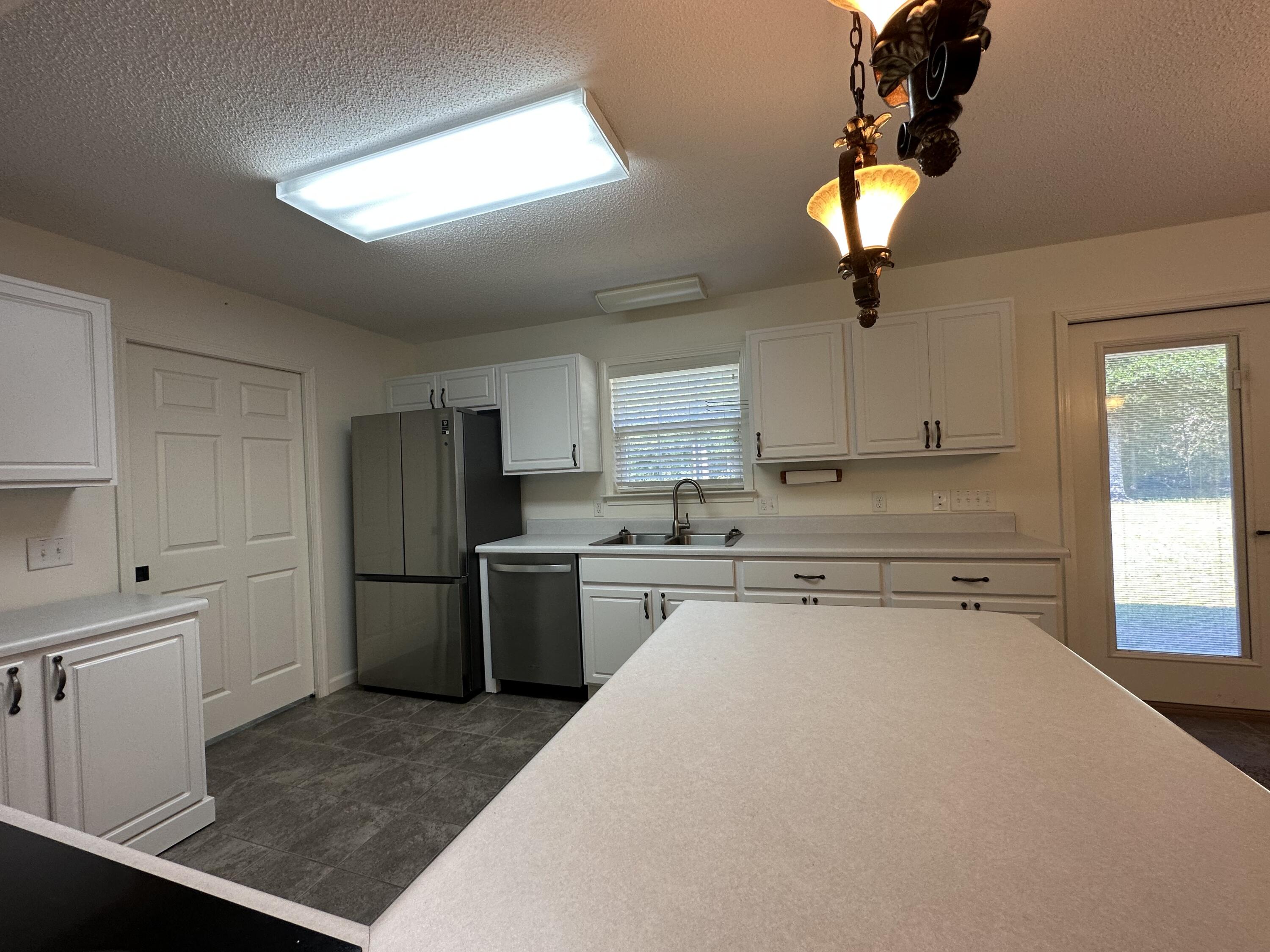 5570 Mt Olive Road Crestview, FL 32539 - Photo 17 of 34 a kitchen with a refrigerator and a sink
