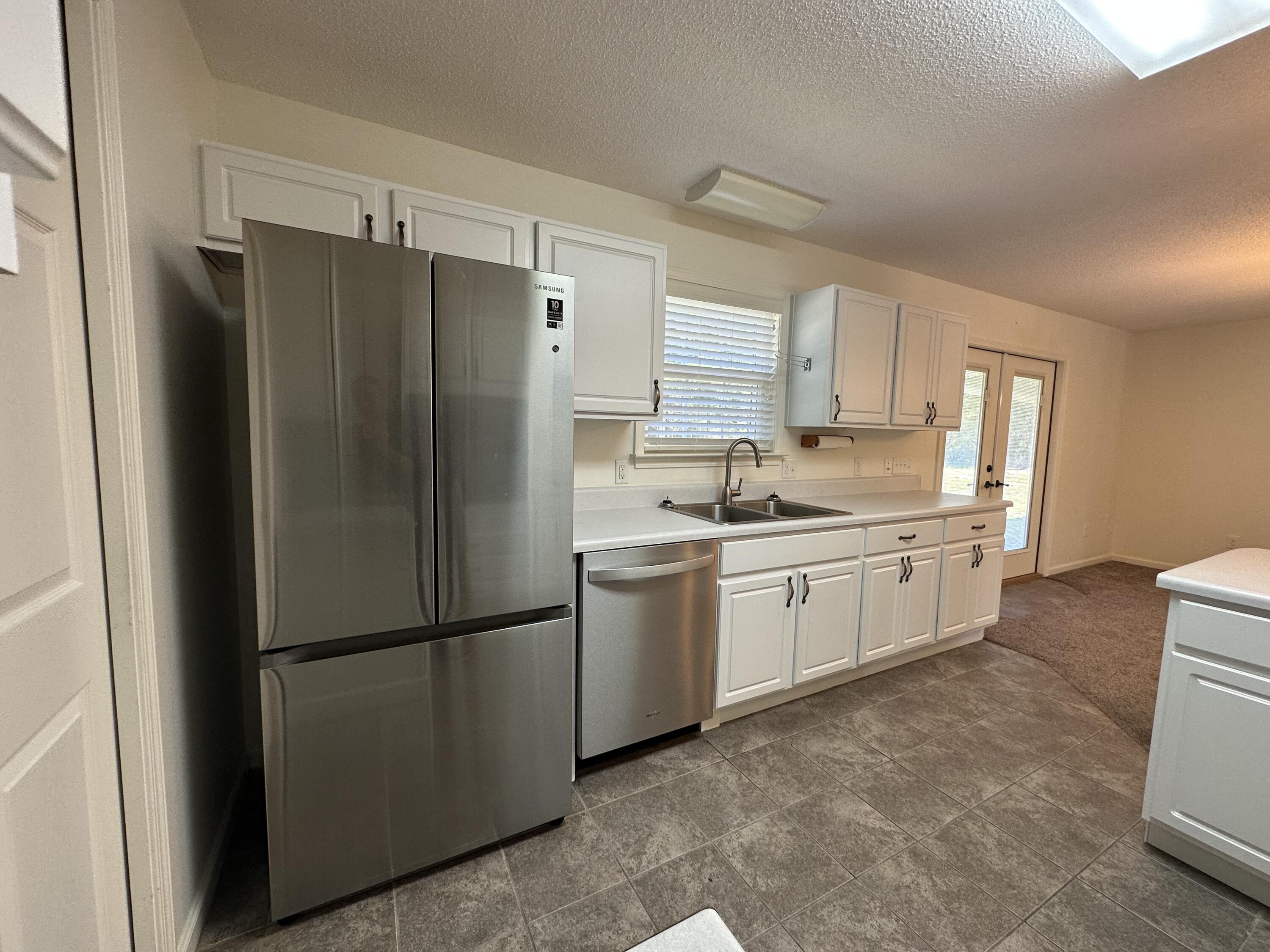 5570 Mt Olive Road Crestview, FL 32539 - Photo 18 of 34 a kitchen with a refrigerator sink and cabinets