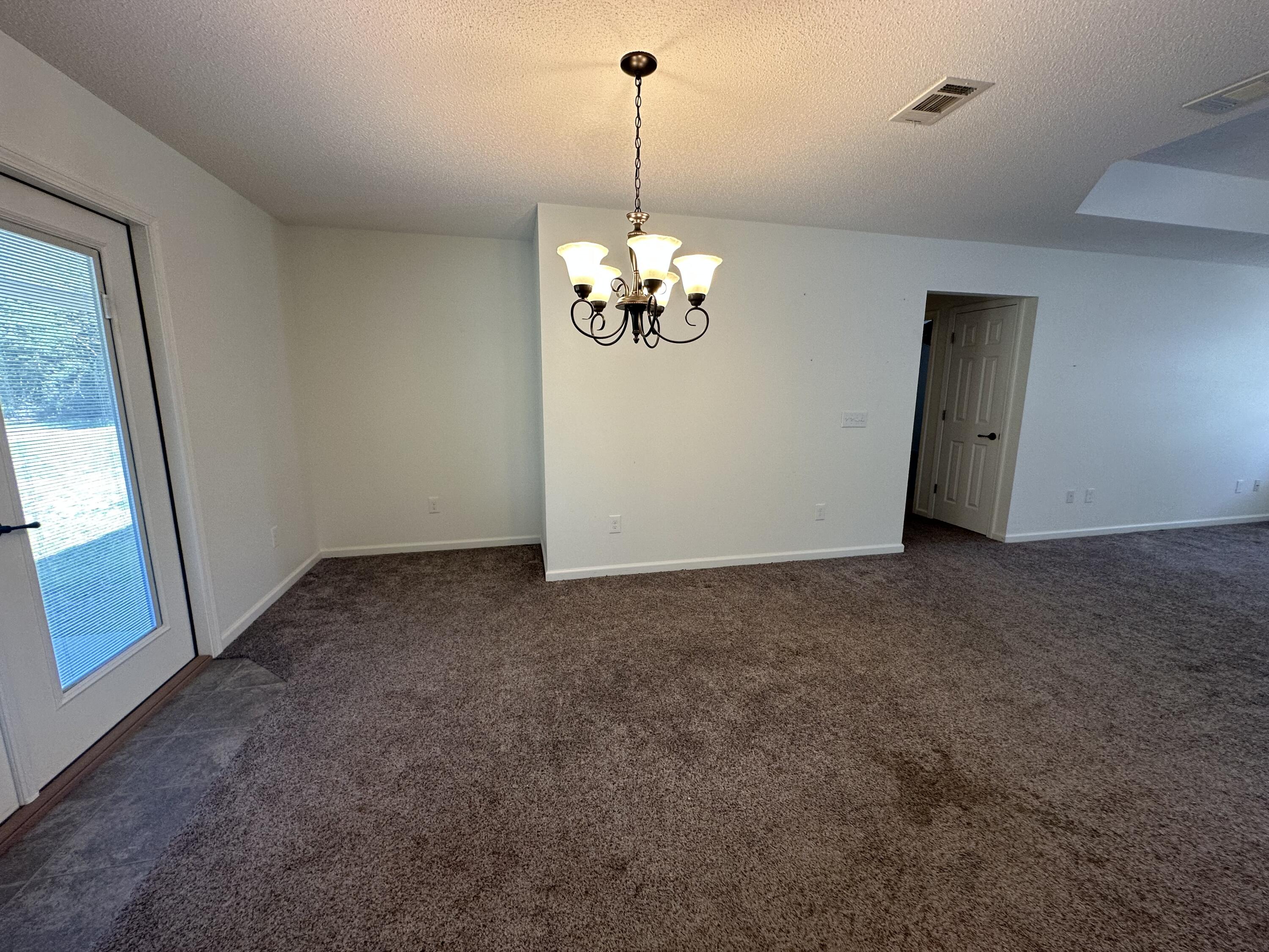 5570 Mt Olive Road Crestview, FL 32539 - Photo 20 of 34 a view of a hallway with a chandelier