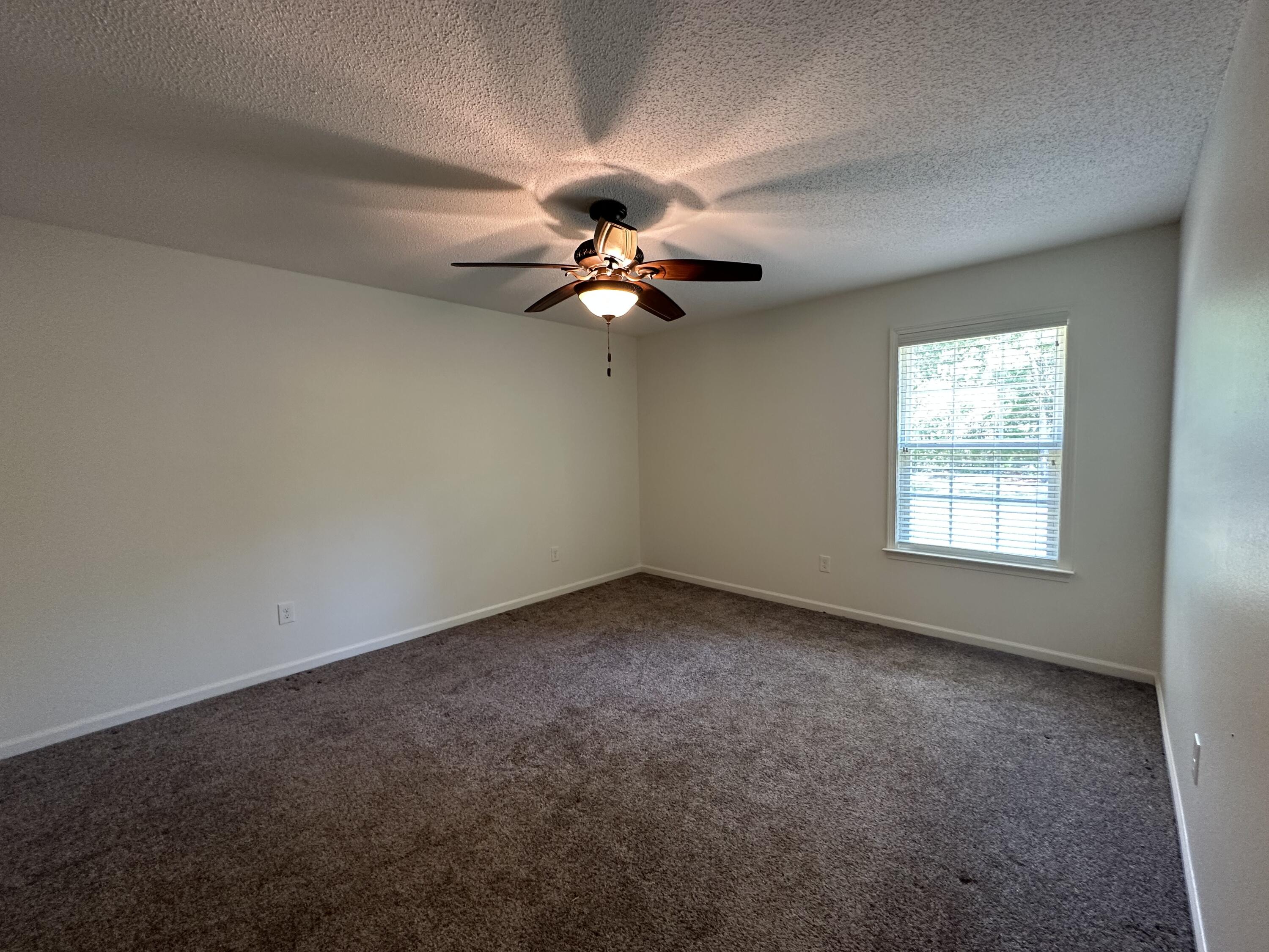 5570 Mt Olive Road Crestview, FL 32539 - Photo 22 of 34 an empty room with a window and a ceiling fan