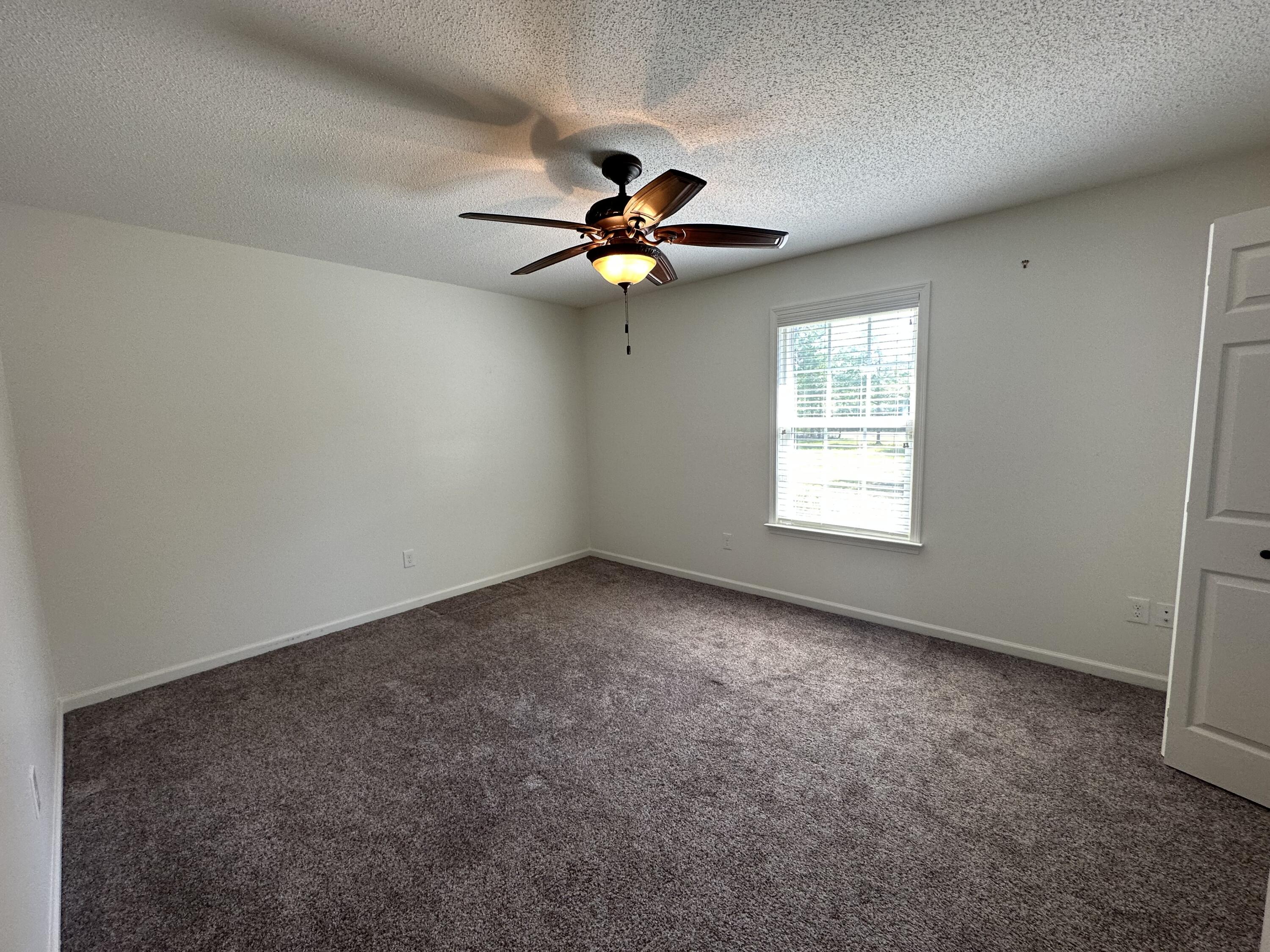 5570 Mt Olive Road Crestview, FL 32539 - Photo 23 of 34 an empty room with windows and fan