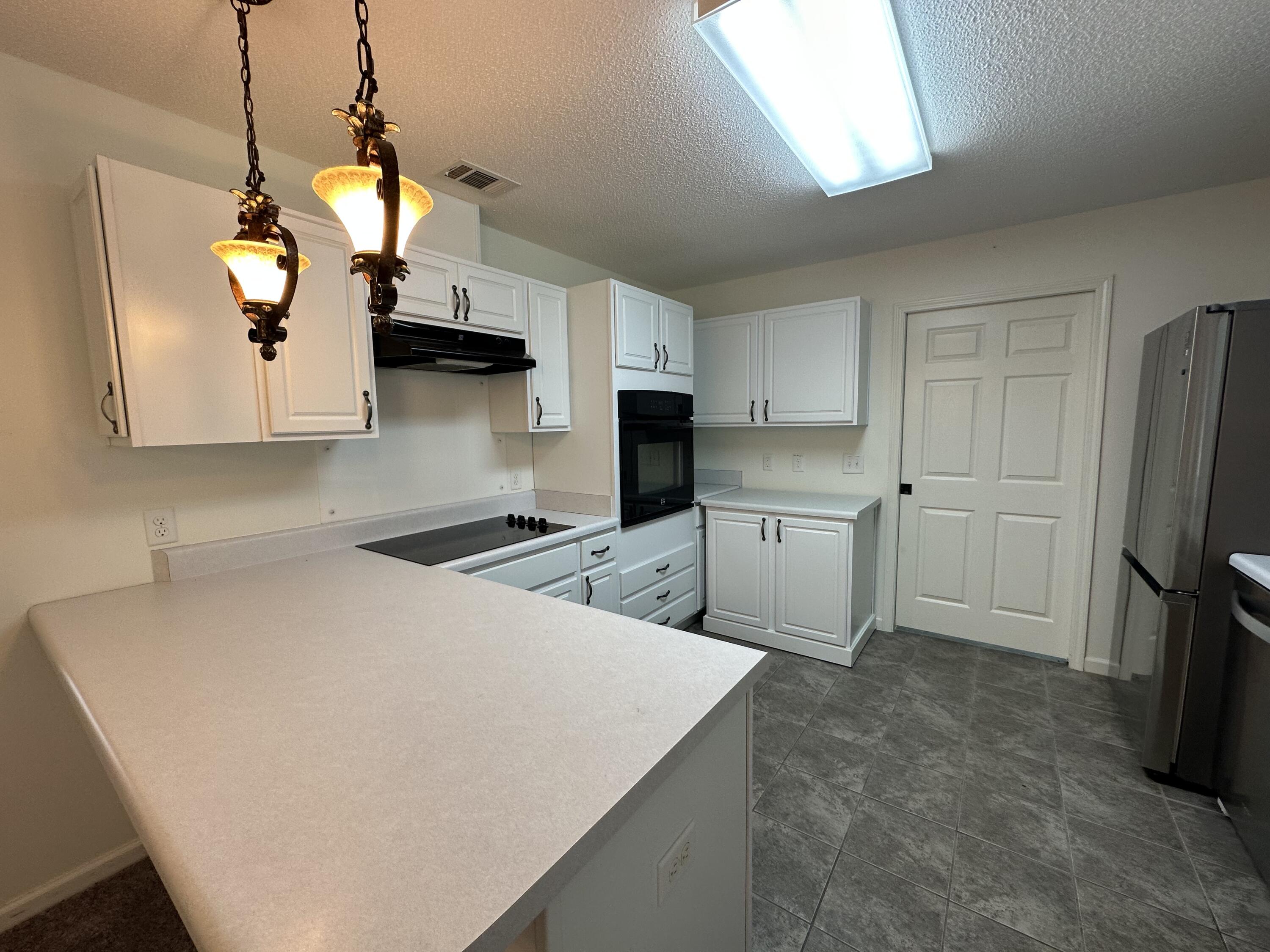 5570 Mt Olive Road Crestview, FL 32539 - Photo 3 of 34 a kitchen with stainless steel appliances a stove a refrigerator a sink a oven and white cabinets