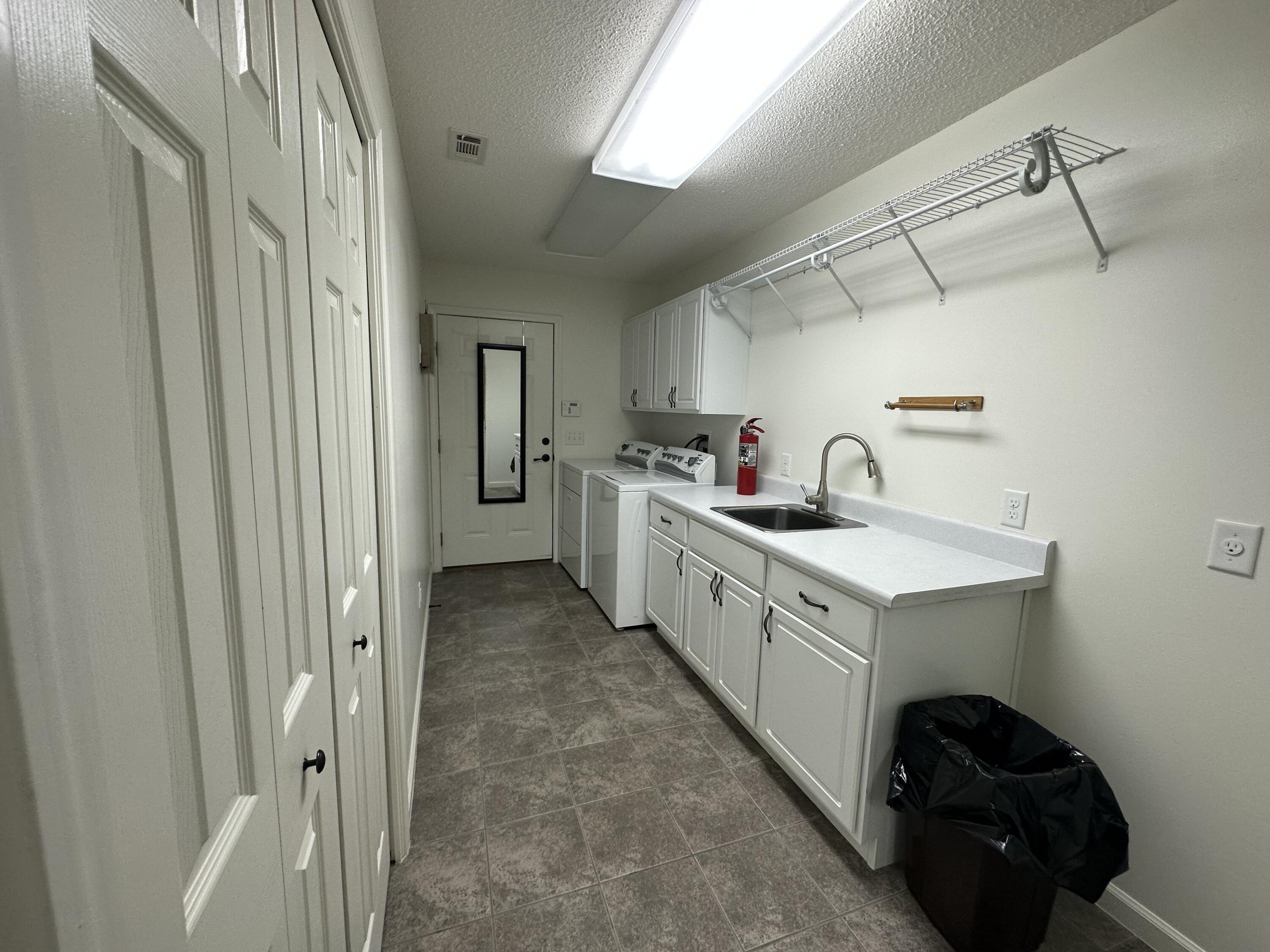 5570 Mt Olive Road Crestview, FL 32539 - Photo 8 of 34 a kitchen with cabinets and white appliances