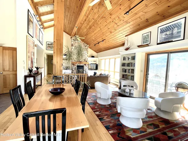 a kitchen with granite countertop a counter space chairs stainless steel appliances and cabinets