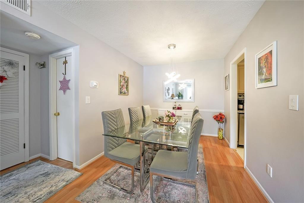 6851 Roswell Road, Unit O3 Atlanta, GA 30328 - Photo 11 of 30 a living room with furniture and wooden floor