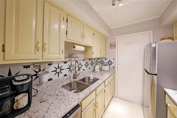 a kitchen with stainless steel appliances granite countertop a sink stove and refrigerator