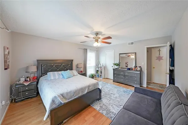 a bedroom with a large bed and a chandelier
