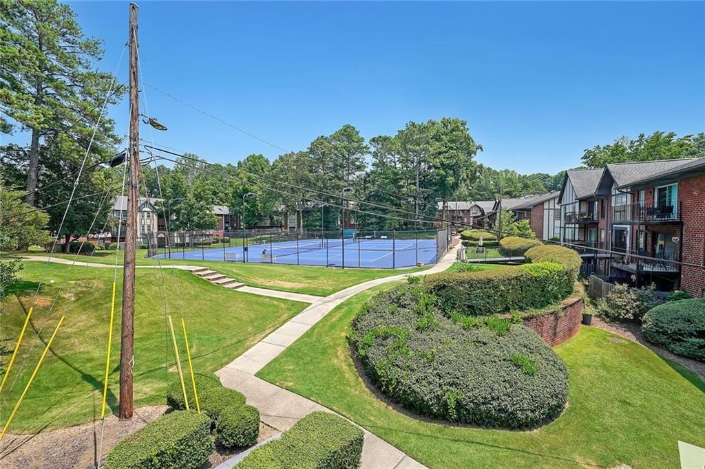 6851 Roswell Road, Unit O3 Atlanta, GA 30328 - Photo 24 of 30 a view of a swimming pool with a house