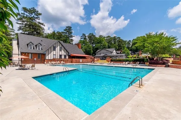 an aerial view of a house with swimming pool garden and patio