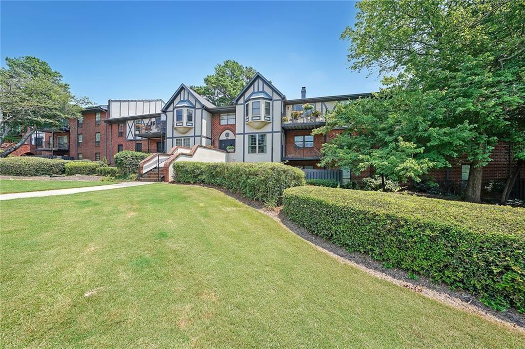6851 Roswell Road, Unit O3 Atlanta, GA 30328 - Photo 4 of 30 a front view of a house with a yard