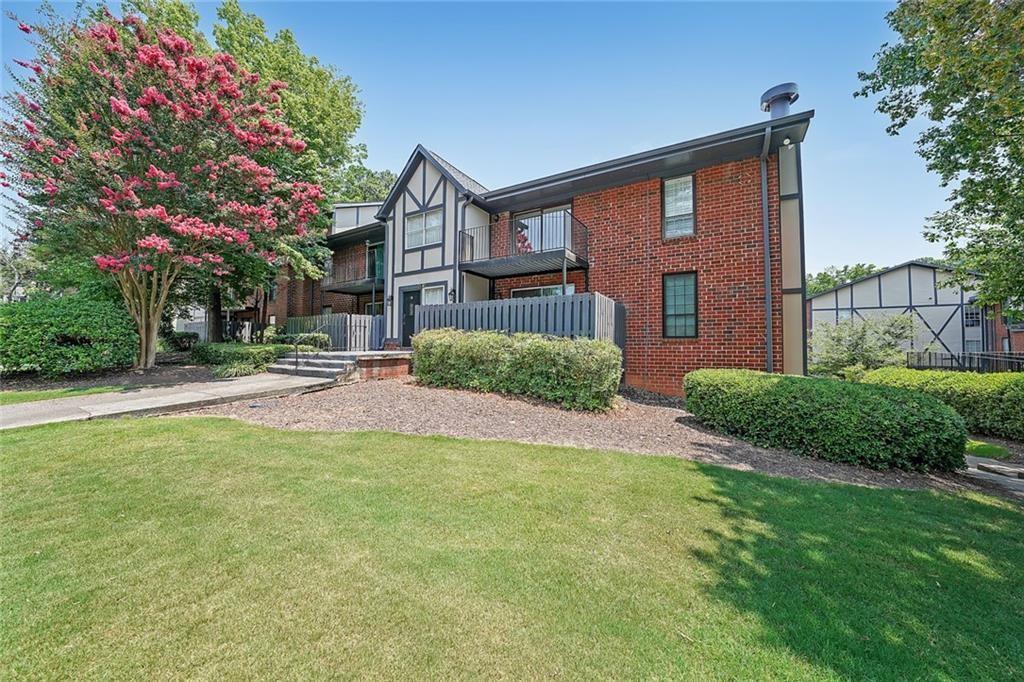 6851 Roswell Road, Unit O3 Atlanta, GA 30328 - Photo 6 of 30 a front view of a house with a yard