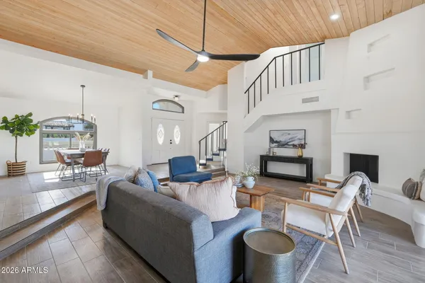 a living room with fireplace furniture and a wooden floor