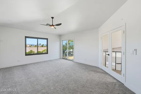 a living room with furniture and a floor to ceiling window