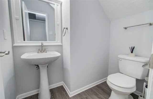 a bathroom with a sink toilet and a mirror