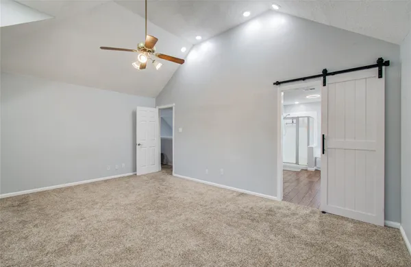 a view of an empty room with a ceiling fan