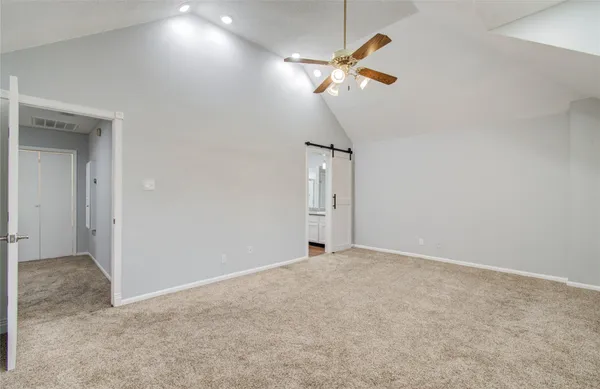 an empty room with a chandelier fan and a chandelier fan