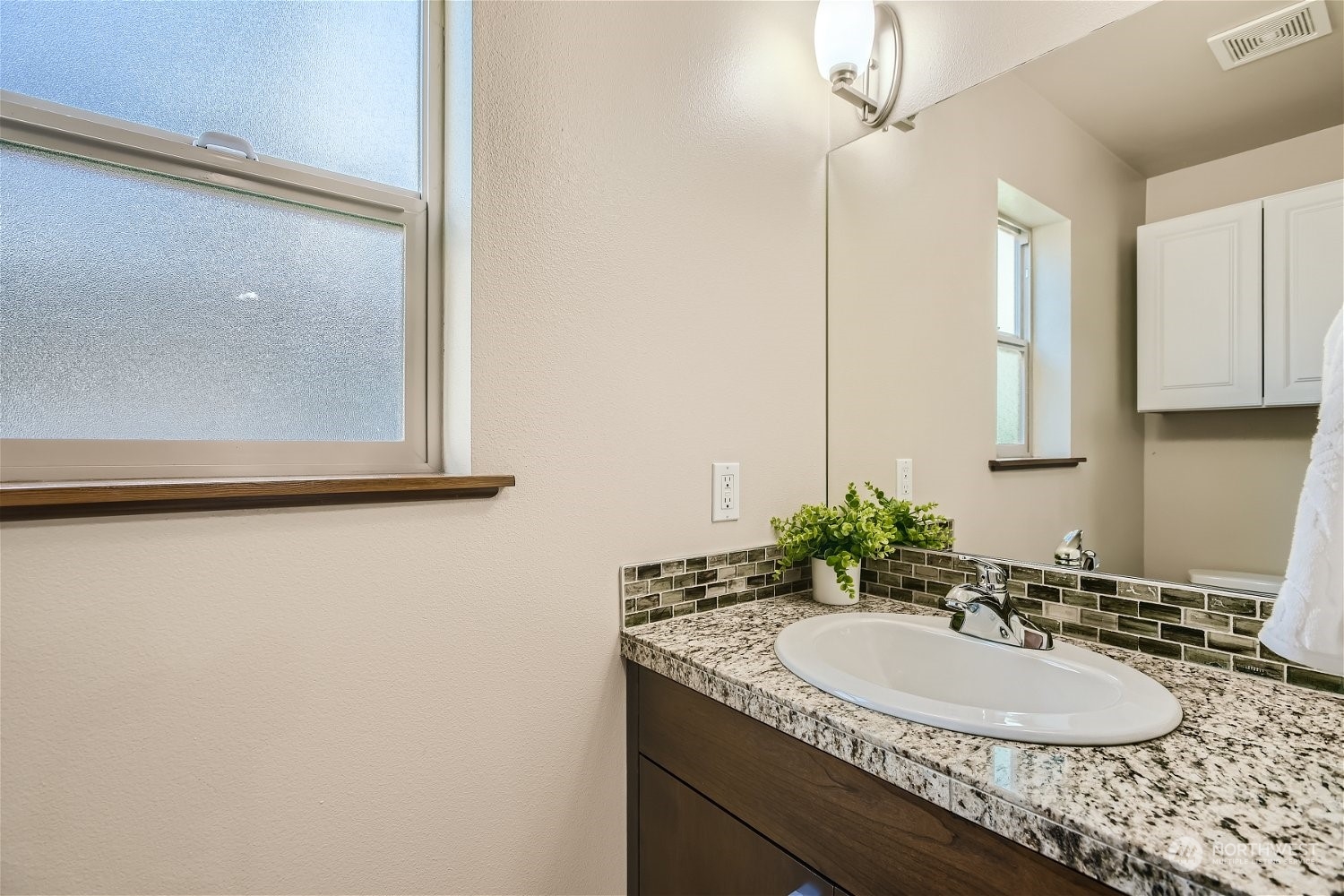 5935 California Avenue Southwest Seattle, WA 98136 - Photo 19 of 32 a bathroom with a granite countertop sink and a mirror