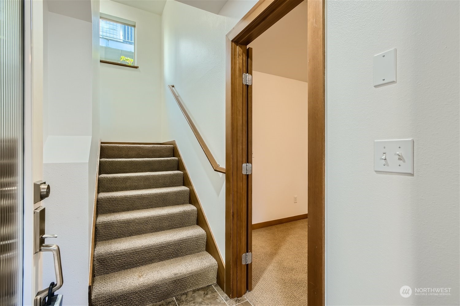 5935 California Avenue Southwest Seattle, WA 98136 - Photo 5 of 32 a view of staircase with wooden floor and white door