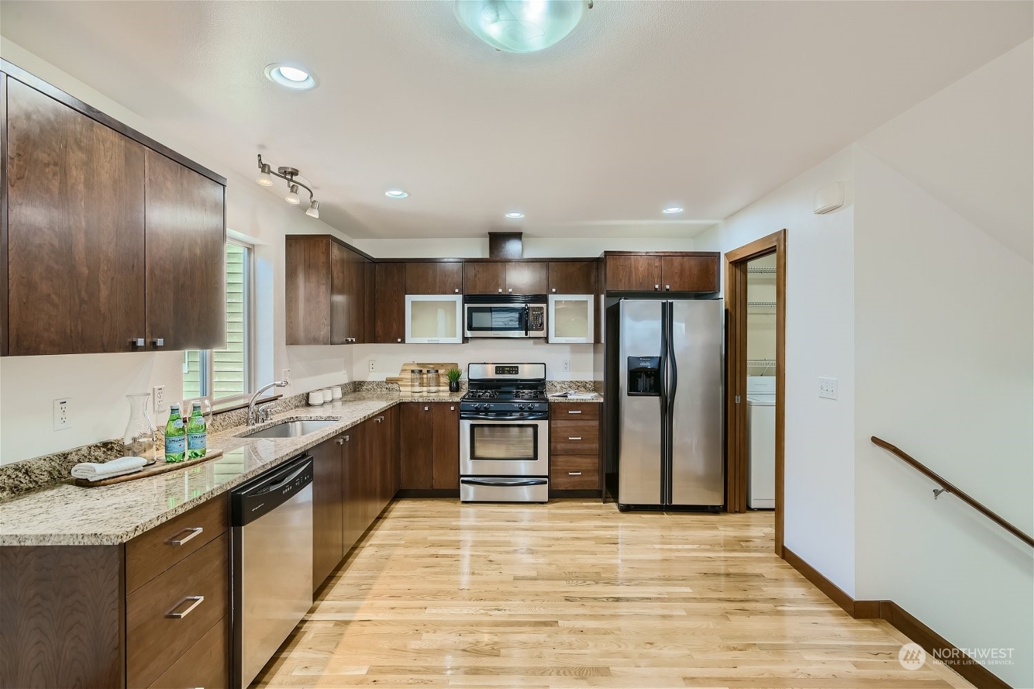 5935 California Avenue Southwest Seattle, WA 98136 - Photo 8 of 32 a kitchen with stainless steel appliances granite countertop a sink stove and refrigerator