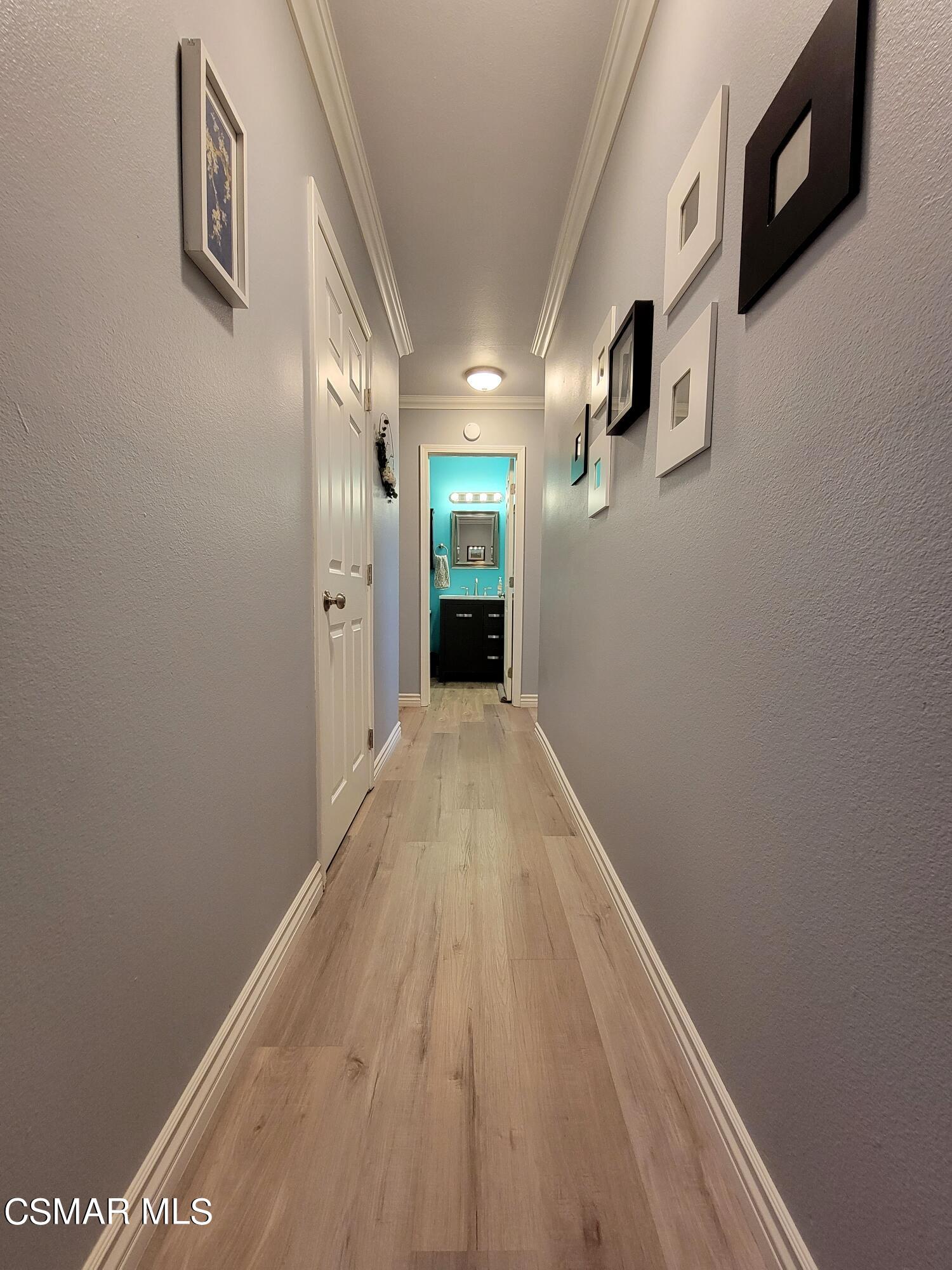 13368 East Quail Summit Road Moorpark, CA 93021 - Photo 14 of 22 a view of a hallway with wooden floor